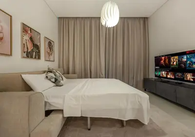 a bedroom with a white bed and a couch at Address Residences Stay in Dubai