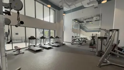 a gym with treadmills and machines in a room at Elite Business & Family Turnkey 433 Residence 2BR in OIA Motor City in Dubai