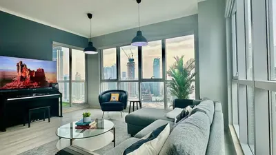 a living room with a couch and a large window at Dubai I Burj Residence Retreat I Piano & Workstation in Dubai