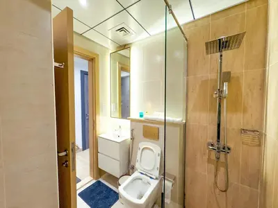 a bathroom with a toilet and a shower at Modern Studio Living in JVC's Regina Tower in Dubai