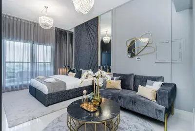 a living room with a bed and a couch at Modern furnishing City Centre Super speed wifi in Dubai