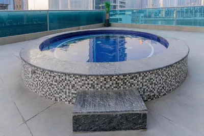 a circular pool with a bench in a building at Modern furnishing City Centre Super speed wifi in Dubai