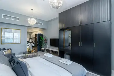 a bedroom with a large bed with black cabinets at Modern furnishing City Centre Super speed wifi in Dubai