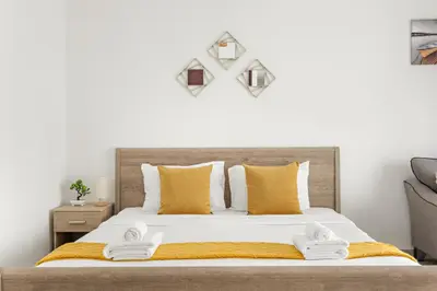 a bedroom with a bed with towels on it at Cozy Studio at DEC Tower in Dubai
