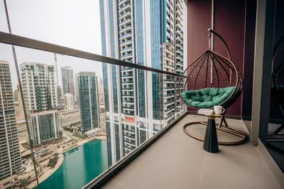 a room with a chair and a view of a city at MBL Royal Luxury 1BR on High Floor in Dubai