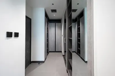 a hallway with white walls and black and white doors at MBL Royal Luxury 1BR on High Floor in Dubai
