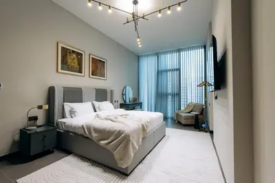 a bedroom with a bed and a chair in it at MBL Royal Luxury 1BR on High Floor in Dubai