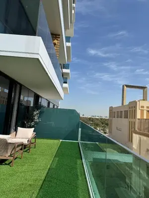 a balcony with green grass on a building at Luxury 1 Bed in the heart of the city! Free WiFi in Dubai