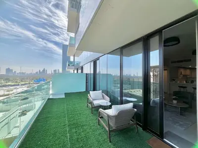 an office balcony with chairs and a green floor at Luxury 1 Bed in the heart of the city! Free WiFi in Dubai