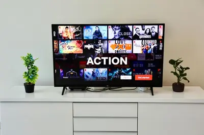 a flat screen tv sitting on top of a white cabinet at Nivis find-Affordable & Spacious 1 BHK- 10 Mins to Dubai Mall in Dubai
