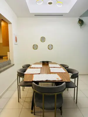 a conference room with a wooden table and chairs at Nivis find-Affordable & Spacious 1 BHK- 10 Mins to Dubai Mall in Dubai