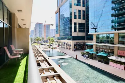 a view of a hotel balcony with a pool and buildings at Nivis find-Affordable & Spacious 1 BHK- 10 Mins to Dubai Mall in Dubai