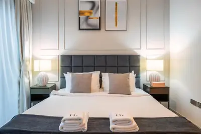 a bedroom with a bed with two towels on it at 2BR Boutique Apartments at Burj Royale - Burj Khalifa & Dubai Mall in Dubai