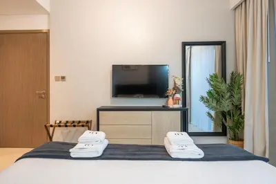 a hotel room with a bed and a flat screen tv at 2BR Boutique Apartments at Burj Royale - Burj Khalifa & Dubai Mall in Dubai