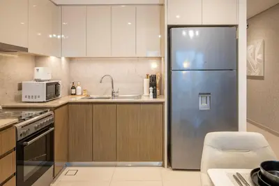 a kitchen with a stainless steel refrigerator at 2BR Boutique Apartments at Burj Royale - Burj Khalifa & Dubai Mall in Dubai