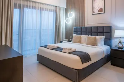 a bedroom with a large bed with a large window at 2BR Boutique Apartments at Burj Royale - Burj Khalifa & Dubai Mall in Dubai