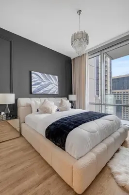 a bedroom with a large bed and a large window at luxury apartment at Al Habtoor city in Dubai