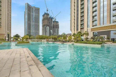a large swimming pool in a city with tall buildings at luxury apartment at Al Habtoor city in Dubai