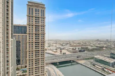 a view of a city with a tall building and a bridge at luxury apartment at Al Habtoor city in Dubai