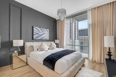a bedroom with a large bed and a large window at luxury apartment at Al Habtoor city in Dubai