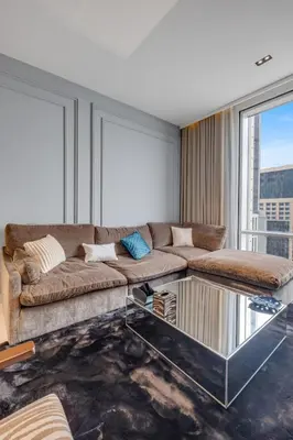 a living room with a couch and a glass coffee table at luxury apartment at Al Habtoor city in Dubai