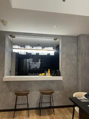 a kitchen with two bar stools and a window at D Stays holiday homes 1min walk to Dubai mall & Burj Khalifa in Dubai