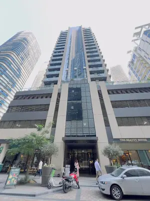 a tall building with cars parked in front of it at D Stays holiday homes 1min walk to Dubai mall & Burj Khalifa in Dubai