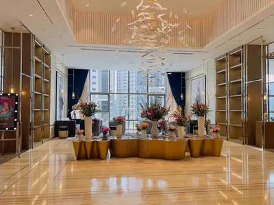 a large room with a table with flowers on it at Exclusive 1BR with Iconic Views in Paramount Tower in Dubai