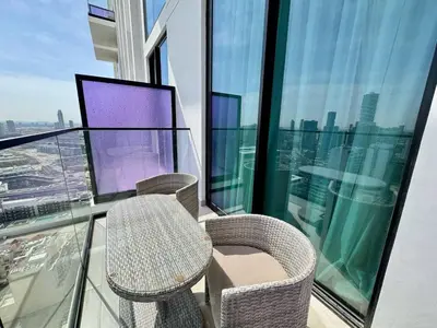 a balcony with a table and chairs on a building at Modern Studio Apt Balcony & Free Parking Jvc in Dubai