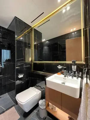 a bathroom with a sink and a toilet and a mirror at Modern Studio Apt Balcony & Free Parking Jvc in Dubai