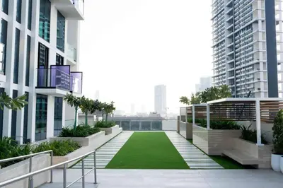 a balcony with a green lawn in the middle of a building at Modern Studio Apt Balcony & Free Parking Jvc in Dubai