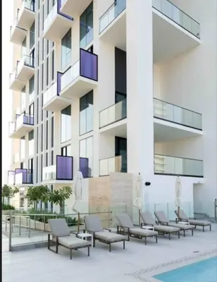 a row of chairs in front of a building at Modern Studio Apt Balcony & Free Parking Jvc in Dubai
