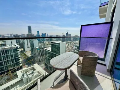 a balcony with a table and chairs on a building at Modern Studio Apt Balcony & Free Parking Jvc in Dubai