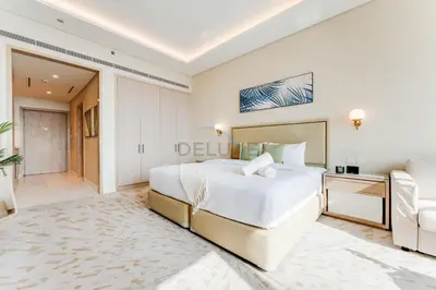 a large white bedroom with a large bed and a couch at High-Rise Studio Overlooking the Sea with a Glimpse of Ain Dubai, The Palm Tower, Palm Jumeirah by Deluxe Holiday Homes in Dubai