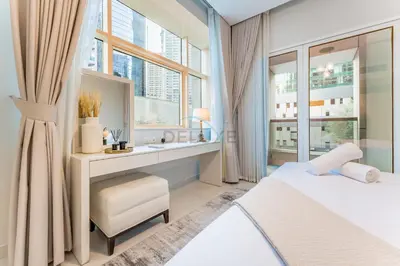 a bedroom with a bed and a sink and a mirror at Pool and City View 1BR Near Dubai Water Canal, The Cosmopolitan, Business Bay by Deluxe Holiday Homes in Dubai
