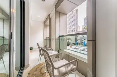 a room with three chairs and a window at Pool and City View 1BR Near Dubai Water Canal, The Cosmopolitan, Business Bay by Deluxe Holiday Homes in Dubai