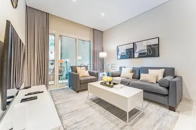 a living room with a couch and a table at Pool and City View 1BR Near Dubai Water Canal, The Cosmopolitan, Business Bay by Deluxe Holiday Homes in Dubai