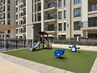 a playground in front of a apartment building at Frank Porter - Hayat Boulevard 2B in Dubai