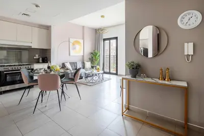 a kitchen and living room with a table and chairs at Frank Porter - Hayat Boulevard 2B in Dubai