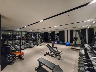 a gym with a lot of treadmills and machines at EasyGo- Luxury 1BR with Burj Khalifa view and lavish Amenities in Dubai
