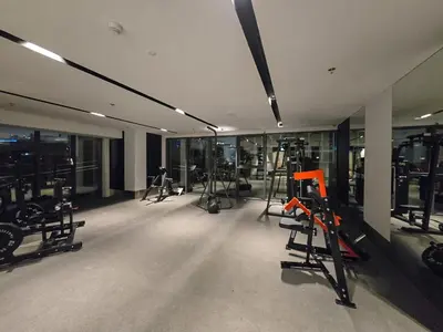 a gym with several treadmills and exercise bikes at EasyGo- Luxury 1BR with Burj Khalifa view and lavish Amenities in Dubai