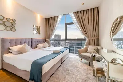 a bedroom with a large bed and a large window at FAM Living -Duplex 4Bed and Maids in Dubai