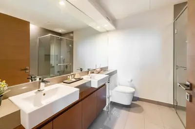 a bathroom with two sinks and a toilet at FAM Living -Duplex 4Bed and Maids in Dubai