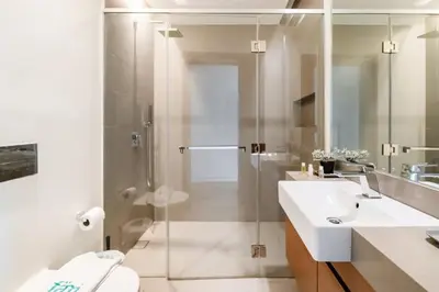 a bathroom with a glass shower and a sink at FAM Living -Duplex 4Bed and Maids in Dubai
