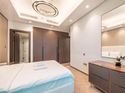 a bedroom with a large bed and a large mirror at Modern 1-Bed Apartment in a Prime Central Location in Dubai
