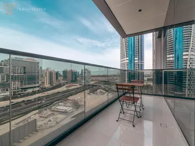a balcony with a table and a view of a city at Modern 1-Bed Apartment in a Prime Central Location in Dubai