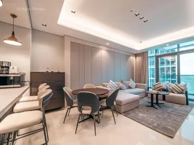 a kitchen and living room with a table and chairs at Modern 1-Bed Apartment in a Prime Central Location in Dubai