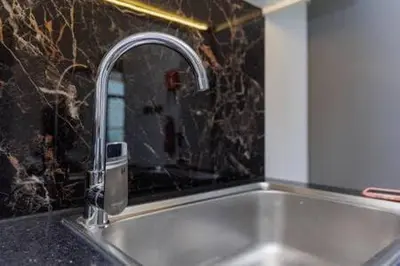 a sink with a faucet in a kitchen at Contemporary 2 Bedroom Apartment in Dubai