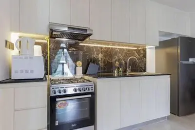 a kitchen with a stove and a counter top at Contemporary 2 Bedroom Apartment in Dubai