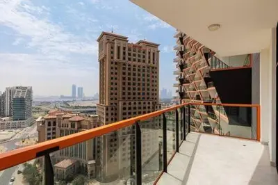 a balcony with a view of a city with tall buildings at Contemporary 2 Bedroom Apartment in Dubai